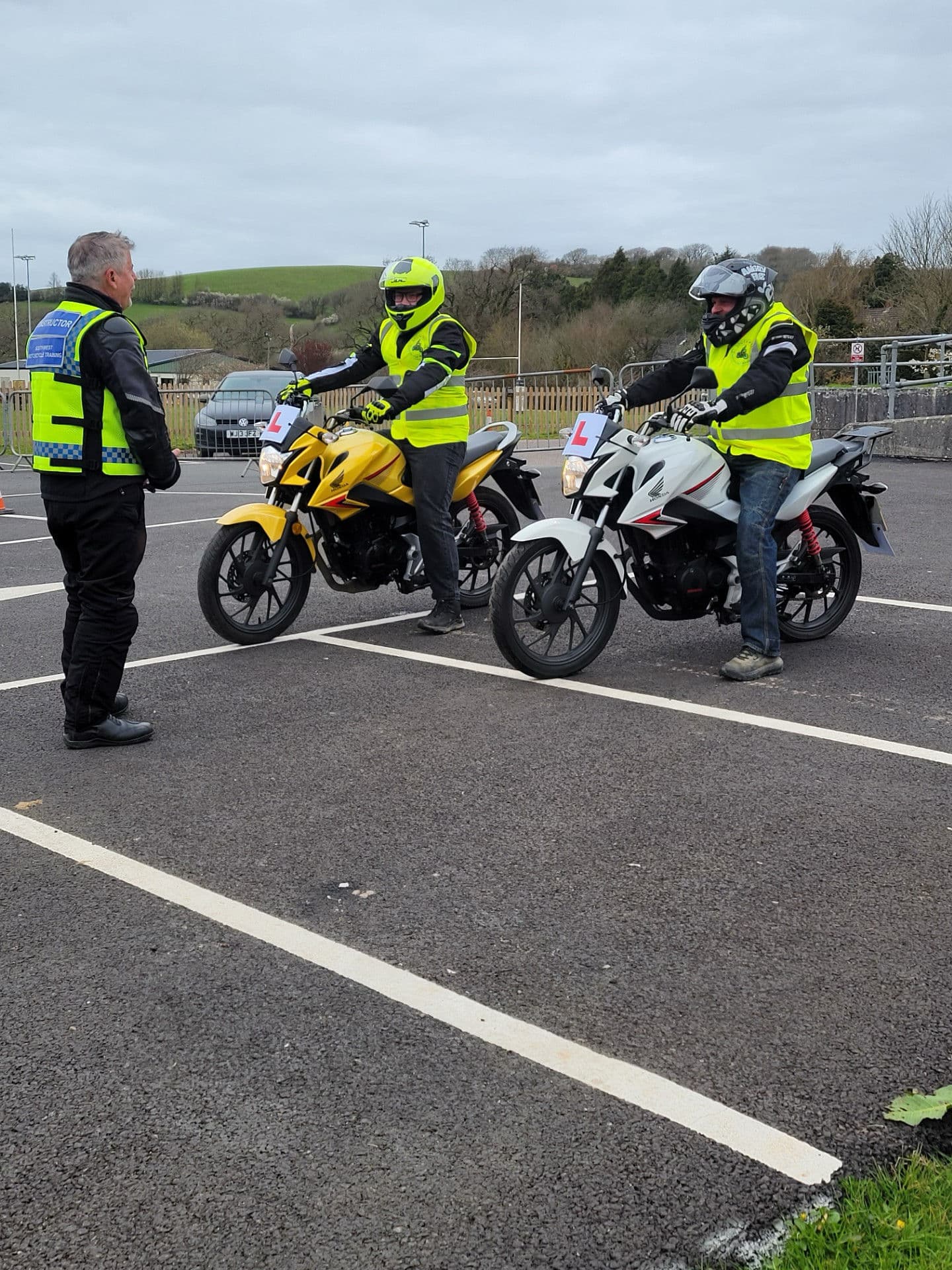 Learner riders on Honda training bikes with a South West Motorcycle Training instructor at North Tawton